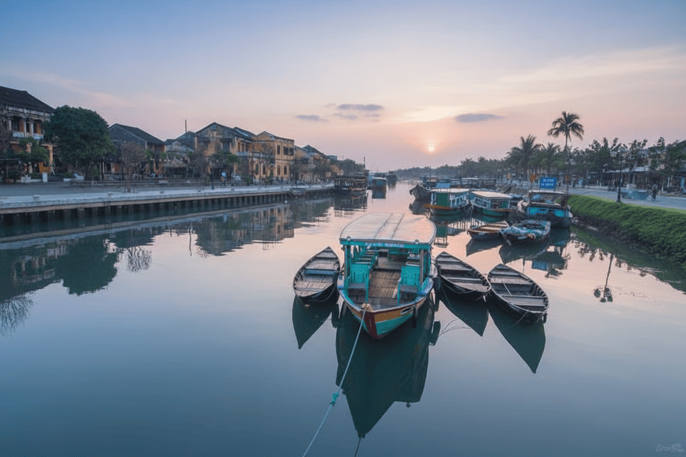 A breathtaking sunrise over the Hoai River in Hoi An, reflecting the town&rsquo;s timeless charm and serenity